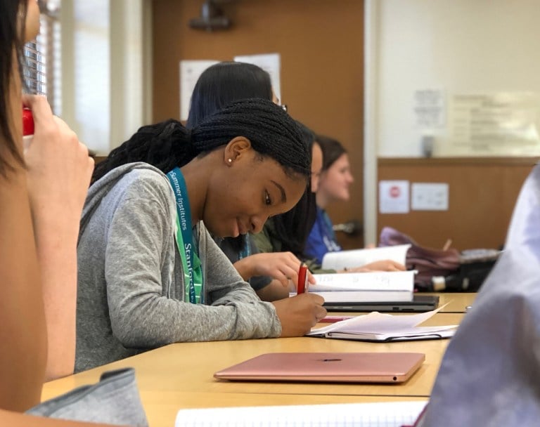 Screenwriting student Ose Uwadiale takes notes at a lecture on active protagonists. (SHREYA HAMBIR/The Stanford Daily)