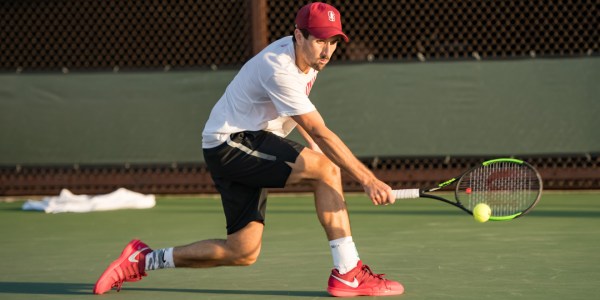 Junior William Genesen hits a low backhand during the ITA regional finals this past weekend. Genesen lost a grueling three-set match, but still clinched a spot in the national tournament.