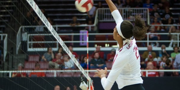 Senior middle blocker Courtney Bowen spikes a ball at the net during a match earlier this season. Bowen had 14 kills in the Cardinal win over Oregon State last Friday, the first of two victories in another undefeated weekend for Stanford.