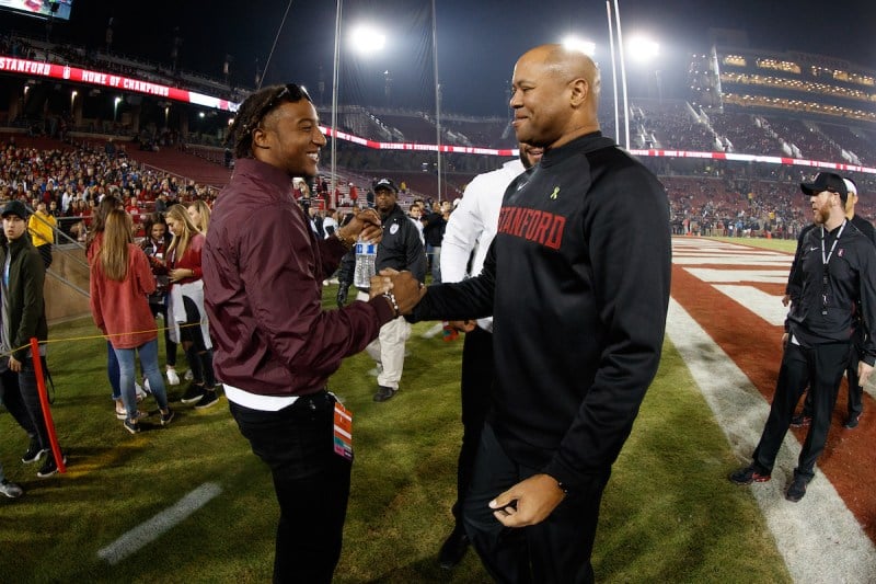 Justin Reid '18 (left) reunites with head coach David Shaw (right) during a bye week after Stanford's win over Oregon State. (BOB DREBIN/isiphotos.com)