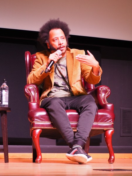 Boots Riley, writer and director of "Sorry to Bother You," speaks at Stanford after a screening of his film. (OLIVIA POPP/The Stanford Daily)