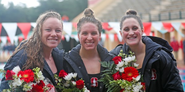 Seniors Ella Eastin, Leah Stevens, and Kim Williams (left to right above) won their final dual meet in Avery Aquatics Center against the USC Trojans. The seniors have combined for 23 All-America Honors, 11 Pac-12 titles, 4 Scholar All-Americans, and 13 National Titles. (TONY SVENSSON/Trimarket Photos)