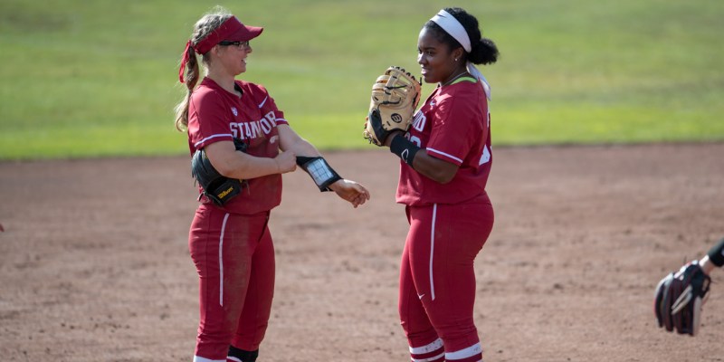 Freshman utility Emily Klingaman (left) helped clinch the game for the Cardinal after hitting a grounder to short with the score tied at 2-2. Senior infielder Whitney Burks (right) finished the night two for three with two runs scored and four RBIs. (JOHN P. LOZANO/isiphotos.com)