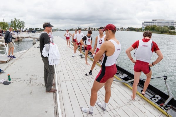 Men's rowing head coach Craig Amerkhanian (above in black) talks to the Varsity Eight ahead of the 2018 Big Row versus the University of California, Berkeley. Amerkhanian announced his retirement Thursday afternoon, and the team’s first competition without him at the helm will be the 2019 Big Row on April 27. (BOB DREBIN/isiphotos.com)