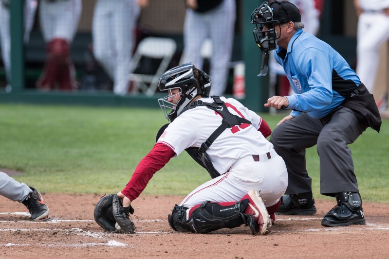 Junior catcher Maverick Handley (above) recorded a pickoff and caught a runner trying to steal in Saturday's 2-7 postseason loss to Fresno State.  (KAREN AMBROSE HICKEY/isiphotos.com)