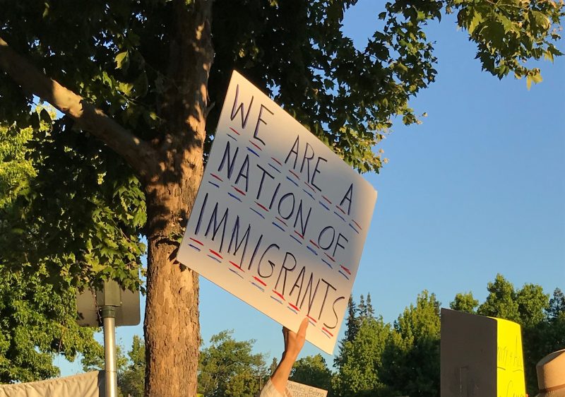 Protesters hold up signs opposing the separation of migrant families at the border. (ESTHER SUN/The Stanford Daily)