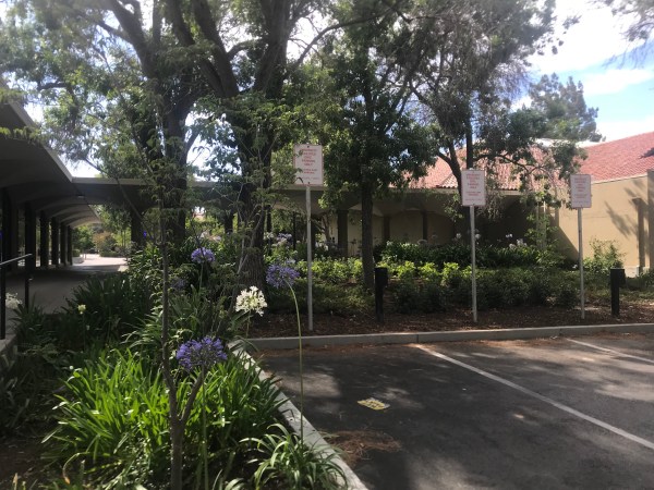 Parking installed to increase efficiency of campus service work as part of the District Work Centers project has closed off much of the passage between the Stanford Bookstore and post office. (HOLDEN FOREMAN/The Stanford Daily)