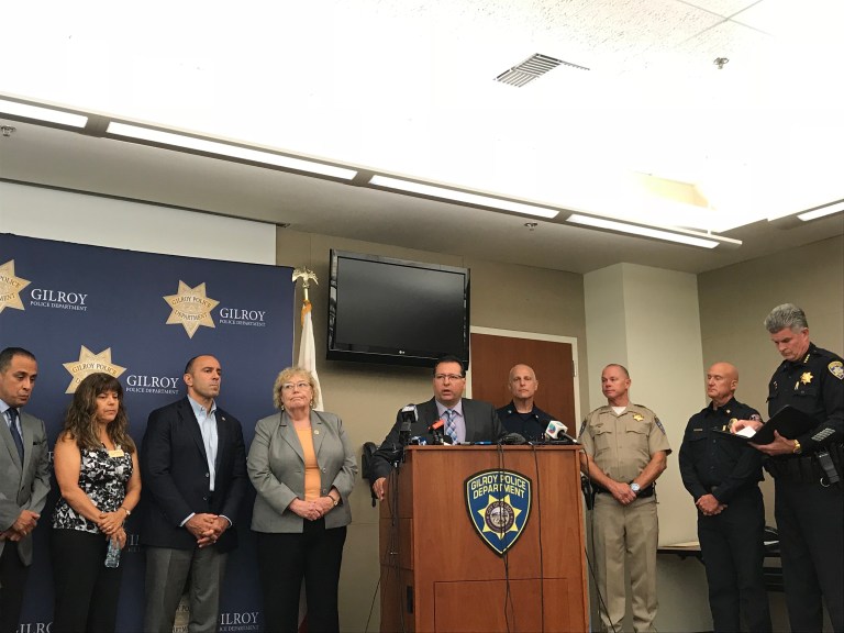 Gilroy Mayor Roland Velasco briefs members of the media after Sunday's mass shooting at the Gilroy Garlic Festival, as Police Chief Scot Smithee stands  nearby. (ERIN WOO/The Stanford Daily)