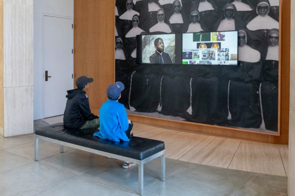 Visitors of Stanford's Cantor Arts Center observe video images in BLKNWS, a work of art crafted by Kahlil Joseph. (Photo: L.A. CICERO/Stanford News)