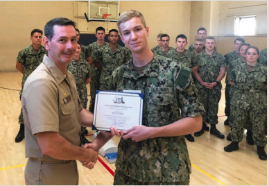 Chris Rielage '21 (right) receives an academic scholarship from his Naval Sciences professor, Captain Jerrod Devine, who at the time of the photo was the commanding officer at UC Berkeley's Navy Reserve Officer Training Corps (NROTC). (Photo courtesy of Naval Historical Foundation)