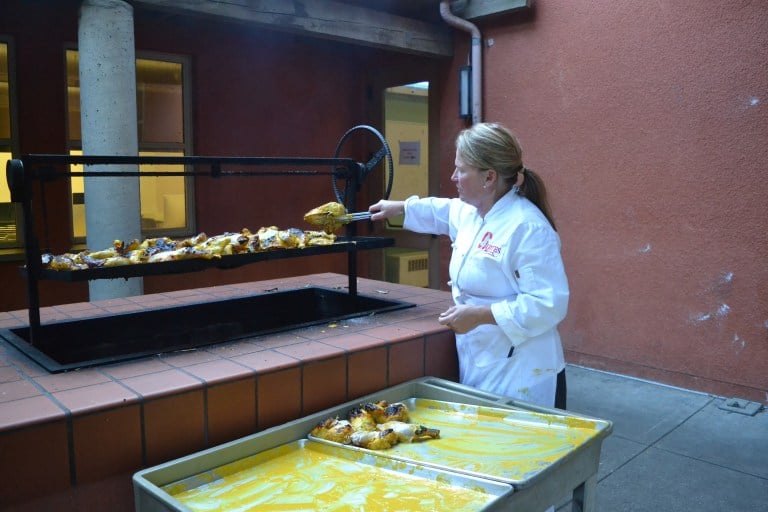 Chef transfers food into bins.