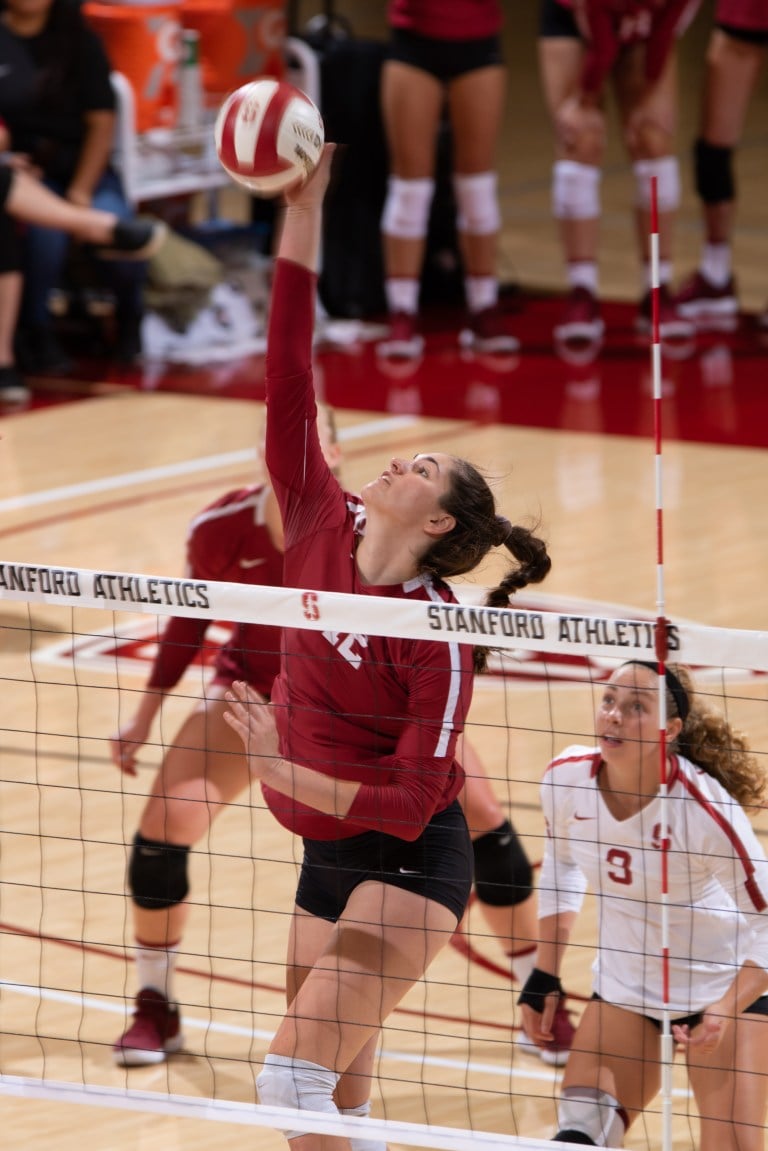 Senior opposite Audriana Fitzmorris (center) recorded a team-high nine kills on a supremely efficient .615 hitting against Colorado.  Senior libero Morgan Hentz (right) tallied three of the team's 11 aces from the service line.  (MIKE RASAY/isiphotos.com)