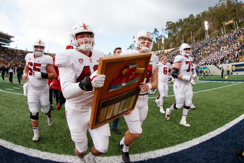 Fifth-year inside linebacker Ryan Beecher (above left) carried the Axe out to midfield after last year’s Big Game victory in Berkeley. In his final season, Beecher has seen his role grow due to injuries in the inside linebacker room. (BOB DREBIN/isiphotos.com)
