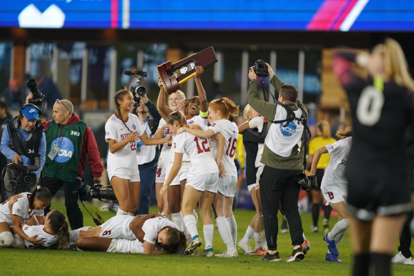 Sophomore center back Naomi Girma, a San Jose native, hoists the 2019 national championship trophy at Avaya Stadium. The captain buried a penalty kick and spearheaded a defense that allowed just 12 goals in the title-winning season. (Photo courtesy of Stanford Athletics)