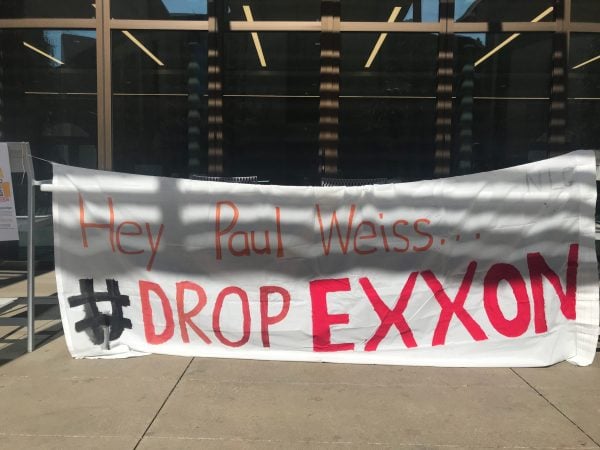 Stanford Law School students tabled and hung posters around the school to convince students to sign a pledge not to work at Paul Weiss, a law firm that has come under fire for its work defending ExxonMobil. (Photo: ERIN WOO / The Stanford Daily)