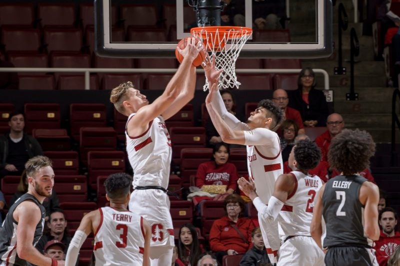 Sophomore forward Lukas Kisunas (above, left) made a slam dunk with just over 11 minutes left in the game. His score proved to be crucial in shifting momentum in favor of the Cardinal. (KAREN AMBROSE HICKEY/isiphotos.com)