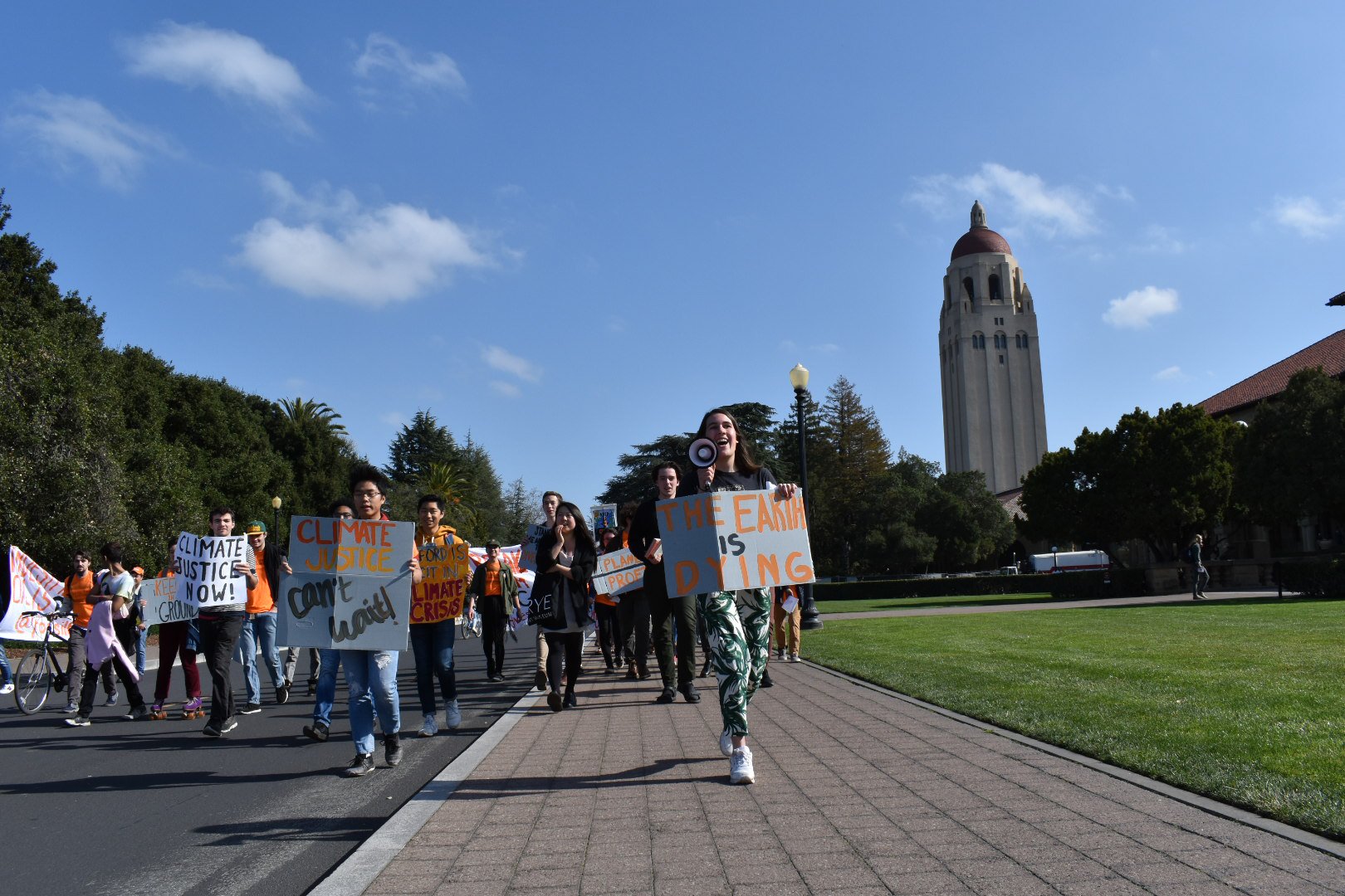 Calling on Stanford to divest from fossil fuels, students marched from White Plaza to Main Quad in February. Pictured are the students as they march down Jane Stanford Way in front of Main Quad.