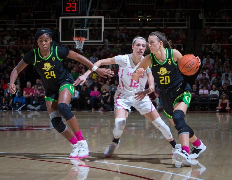 Sabrina Ionescu (above, right) and Ruthy Hebard (above, left) combined for 44 points as the Ducks trounced Stanford in the Pac-12 Championship. Sophomore guard Lexie Hull (above, center) had dropped 28 points the night before, but could only find 9 points against Oregon. (Photo: ERIN CHANG/isiphotos.com)