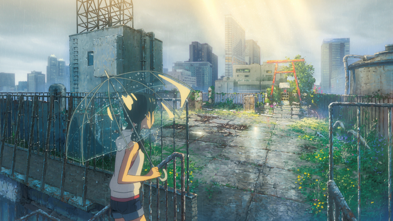 In the animated film “Weathering with You,” the character Hina Amano approaches a shrine gate bathed in sunlight amid the rain. 
(Photo: GKIDS)