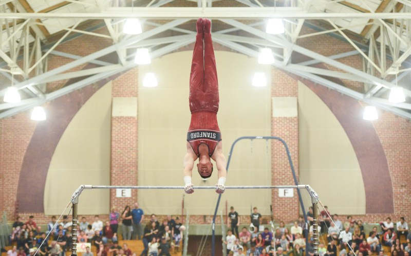 Sophomore Brody Malone (above) feels just as comfortable on the high bars as he does on the back of a steer. (Photo: CODY GLENN/isiphotos.com)