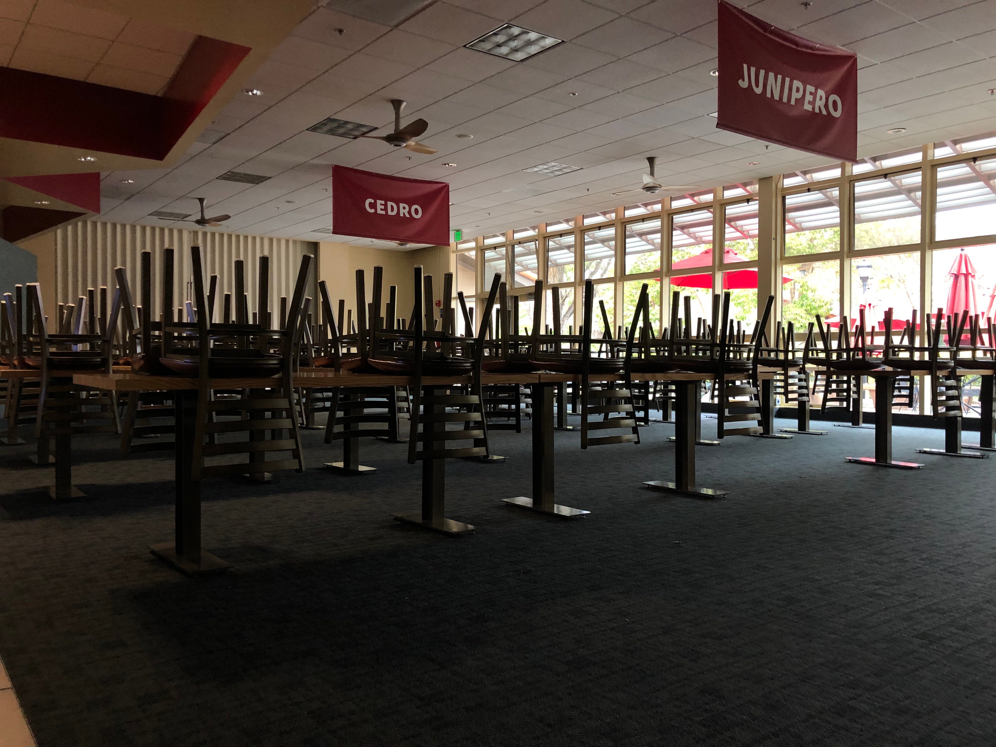 Chairs are placed upside down on tables inside Wibur Dining.