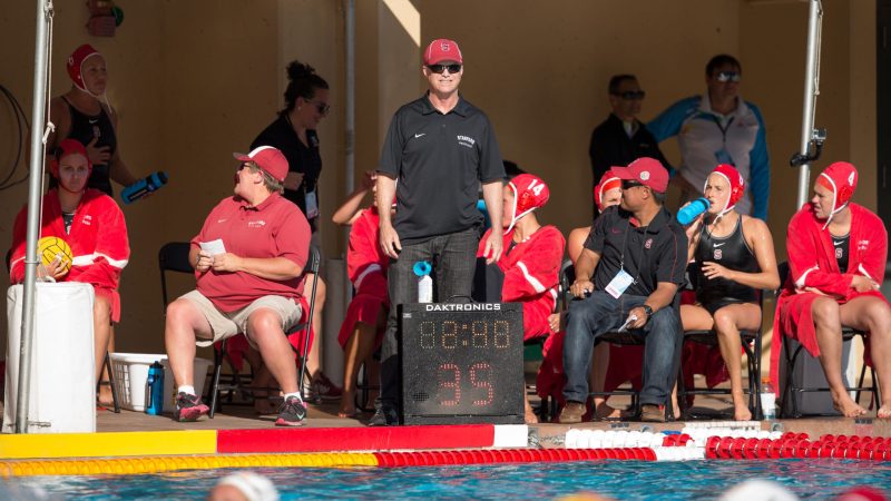 Women’s water polo coach John Tanner (above, center) rallies the 2015 team from the pool deck. The 2019 USA Water Polo Hall of Fame inductee recently concluded his 23rd season at the helm, building a program that has produced seven NCAA Championships (2002, 2011, 2012, 2014, 2015, 2017, 2019) — multiple of which fall into this calendar week. (Photo: BOB DREBIN/isiphotos.com)