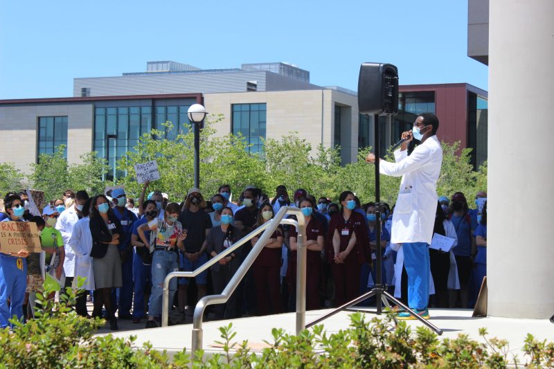 Pediatric resident Kamaal Jones addresses the crowd at Thursday's rally outside of the Li Ka Shing building. (Photo: DANIEL WU/The Stanford Daily)