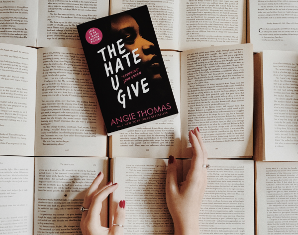 An image of the novel "The Hate U Give" by Angie Thomas on top of other open books. (Amy Buckle / Amy's Bookshelf)