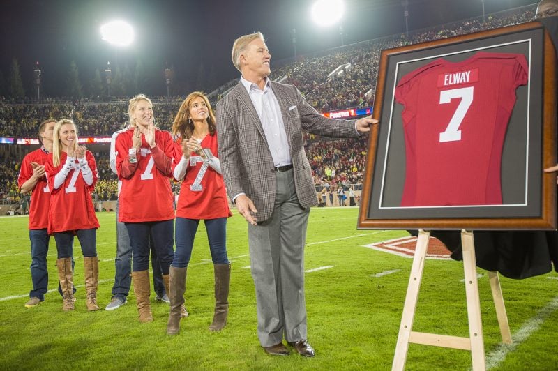 John Elway '83 (above, center) returned to Stanford Stadium in 2013 to see a 26-20 Cardinal victory over Oregon. Elway's biography, written by Jason Cole '84, is set to be released on Sept. 15. (Photo: DAVID BERNAL/isiphotos.com)