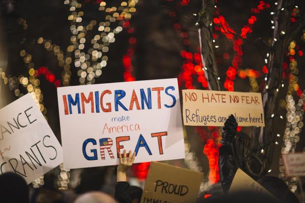 The poster reads "immigrants make America great"
