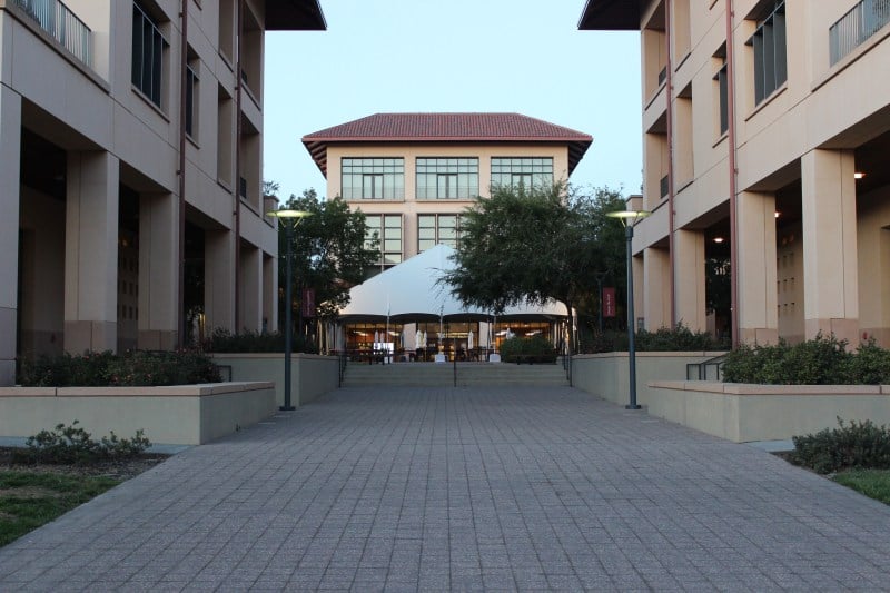 Three buildings at the Graduate School of Business, with two in front on the left and right, and one in the middle back.
