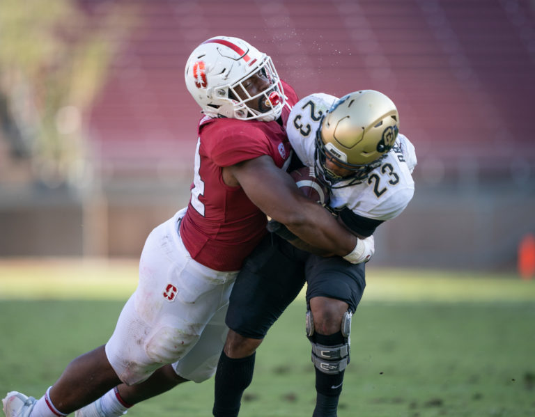 Thomas Booker tackles Jarek Broussard at Stanford's home football stadium.