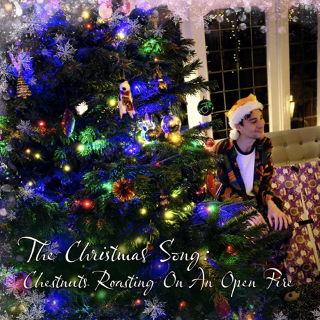 album cover of "The Christmas Song" with a Christmas tree and Jacob Collier sitting next to the tree