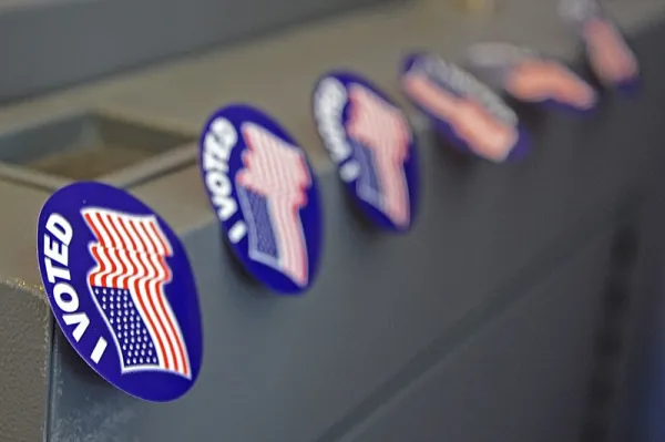 Row of stickers reading "I VOTED" above an American flag.