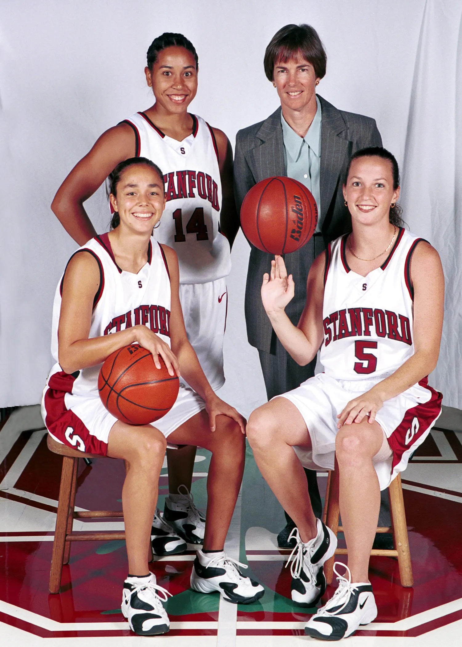 Seniors Milena Flores, Christina Batastini and Yvonne Gbalazeh pose for a photo with Tara Vanderveer during the 1999-2000 women's basketball season at Maples Pavilion.