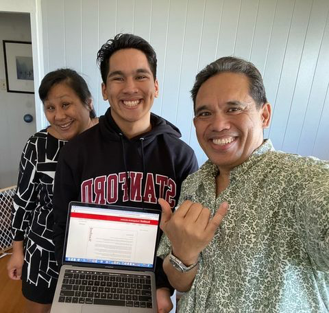 Nainoa Visperas holds his acceptance email while wearing his Stanford gear alongside family members. (Photo: Courtesy of Nainoa Visperas)