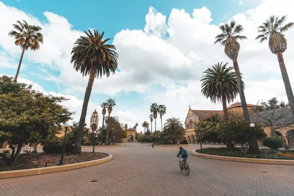 Main quad on a partly cloudy day with a biker