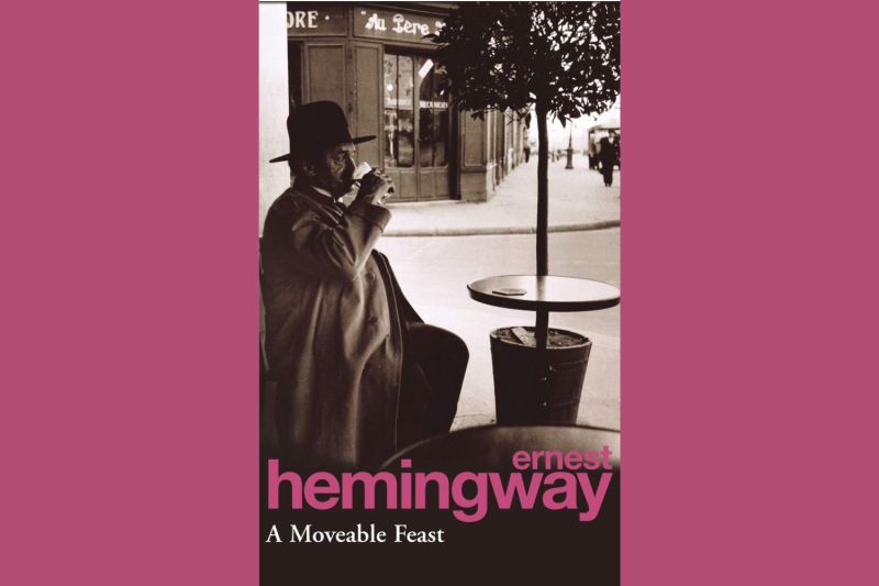black and white cover of hemingway's a moveable feast depicting a seated man drinking a cup of coffee outside a cafe in Paris
