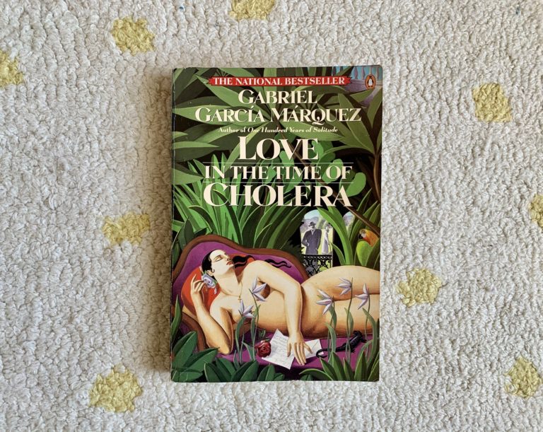 cover image of "Love in the Time of Cholera" - a woman reclining in the foreground amidst leaves