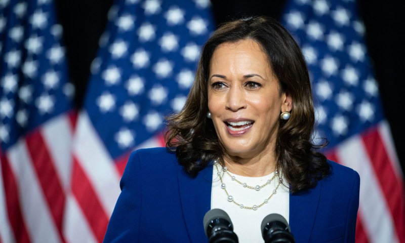 An image of Kamala Harris against flags in the background