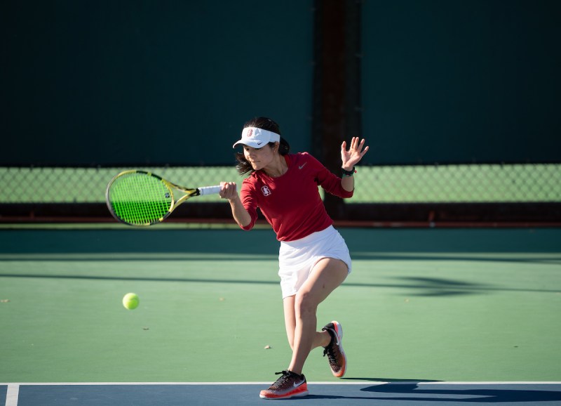 Fifth-yeah Emma Higuchi (above) secured a victory on the six court to help Stanford women's tennis topple Arizona 5-2 on Saturday. The victory was Higuchi's 100th career singles win.(Photo: JOHN TODD/isiphotos.com)