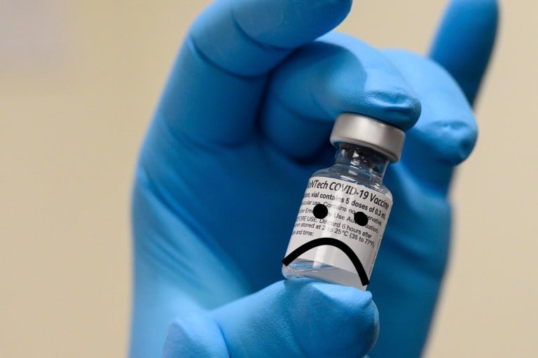 Army Spc. Angel Laureano holds a vial of the COVID-19 vaccine, Walter Reed National Military Medical Center, Bethesda, Md., Dec. 14, 2020. (DoD photo by Lisa Ferdinando)