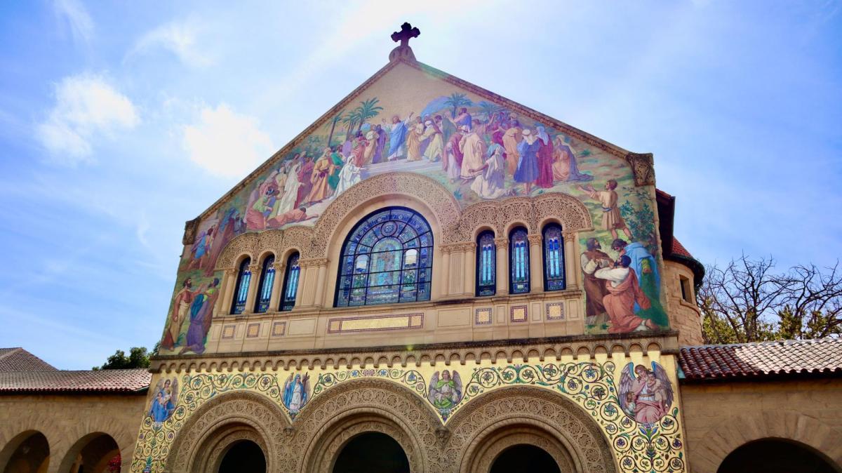 The front facade of memorial church with stained glass windows and painted figures.