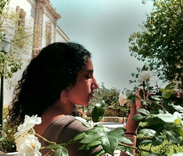 poet Maya Salameh '22 in profile, in some foliage