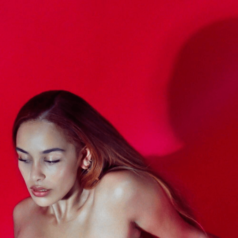 Jorja Smith in front of a red wall