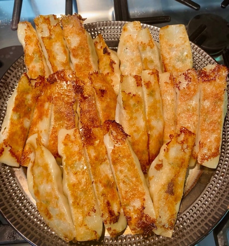 Photo of homemade open-mouth potstickers on a plate