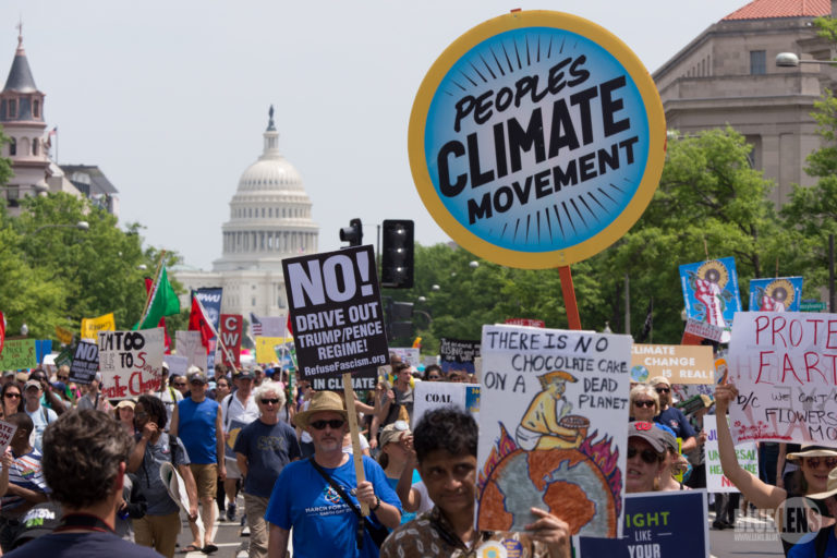 Protestors in favor of climate change action march in front of the U.S. Capitol.