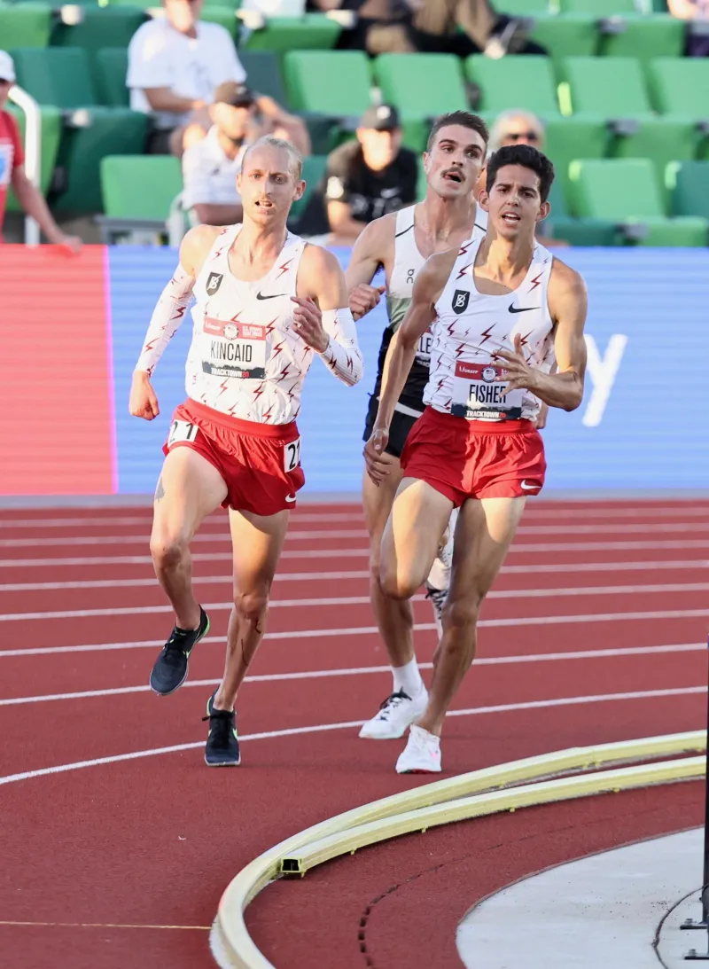 Grant Fisher pictured with two other track athletes in a race