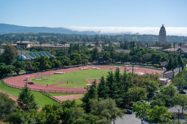A photo of the track and field arena with Hoover Tower in the background