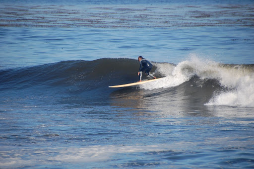 A surfer catches a wave.